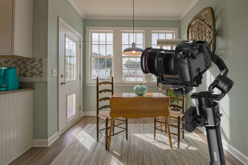 alt="A professional camera mounted to a gimbal pointed at a dining room"